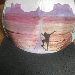 Skateboarder in sunset trucker hat grey